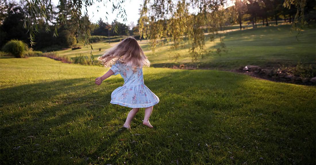 a girl jumping on a lawn